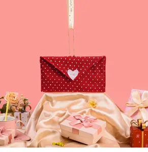 Red envelope gift bag with white polka dots and a central heart for Valentine's decoration