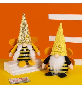 Handmade bumblebee gnomes with sequined and knitted hats for spring festival decor.