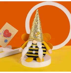 Detailed view of bee festival gnome plush with gold sequin hat and yellow wings