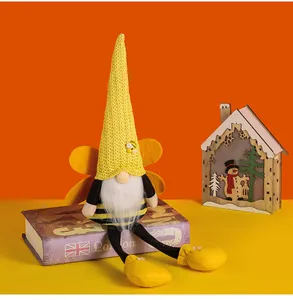 Detailed shot of a plush bumblebee themed long-legged gnome doll with yellow felt wings