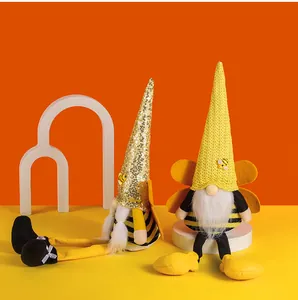 Detailed view of two cute Bee Festival gnomes featuring striped outfits and knitted wings