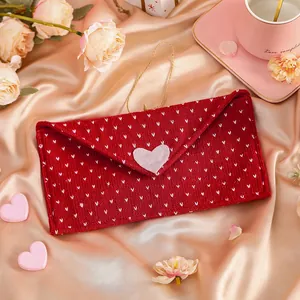 Romantic red knitted envelope with white heart patterns for Valentine's Day gift packaging
