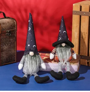 Detail view of two plush Halloween gnomes with pointy witch hats and long dangling legs