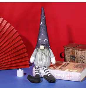 Halloween witch hat gnome doll decoration with long striped legs sitting on vintage book