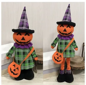 Detail of telescopic Halloween pumpkin witch dolls with green plaid outfit and hat