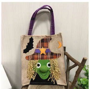 Detailed view of Halloween burlap gift bag featuring a green witch appliqué design.