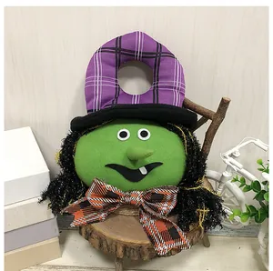 Handmade Halloween green witch door hanger featuring a purple plaid hat and bow decoration