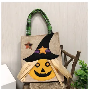 Close-up of a festive Halloween pumpkin tote bag featuring a witch hat and plaid handles.