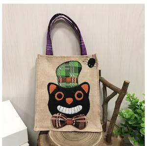 Detailed shot of a burlap Halloween gift bag with black cat design and plaid accents