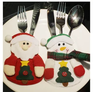 Detail view of festive Santa and Snowman felt cutlery holders for Christmas table settings
