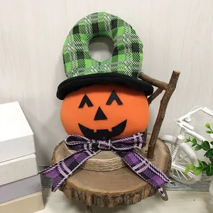 Plush Halloween pumpkin door hanger with green plaid witch hat and purple bow