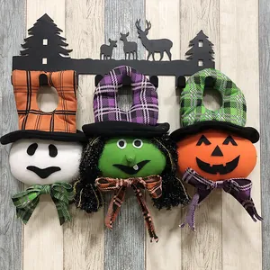 Set of Halloween plush door hangers with ghost witch and pumpkin on a deer metal rack