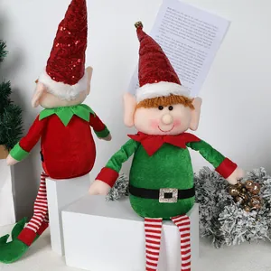 Set of two sitting Christmas elf dolls with long striped legs for home holiday decor.