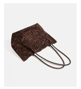 Detailed view of a vintage leopard print suede tote bag with large capacity