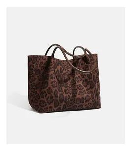 Close-up detail of a vintage leopard print suede tote bag with large storage capacity