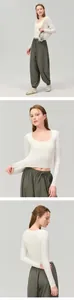 Macro details of white long sleeve cropped yoga top showing elasticity and slim fit