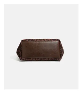 Detailed bottom view of retro leopard print suede tote bag with reinforced brown base