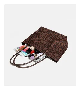 Detailed interior view of leopard print suede tote bag showing its large storage capacity