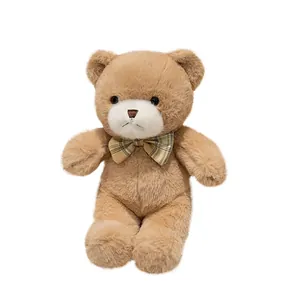 Schattige zachte lichtbruine teddybeer knuffel met een gele geruite vlinderdas