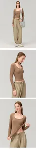 Detail view of brown slim-fit long-sleeve yoga top and khaki joggers on a model.
