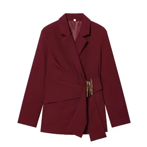 Detail of burgundy blazer featuring a gold buckle and elegant draped waist design.