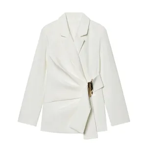 Detail of white blazer jacket with gold metal buckle and asymmetrical draping