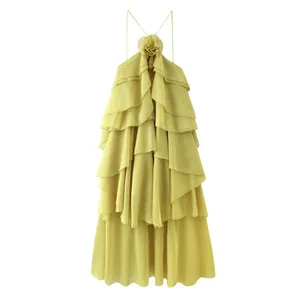 Detailed view of yellow tiered ruffle dress with halter floral neckline.