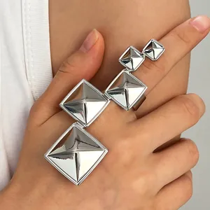 Detailed view of silver geometric pyramid multi-finger statement ring for a bold punk hip-hop look