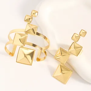 Detailed texture and finish of the gold geometric pyramid bracelet and ring jewelry set