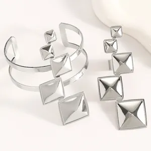 Modern silver pyramid square cascading jewelry set featuring adjustable cuff bracelet and ring