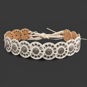 Close-up of bohemian belt featuring white leather discs with metal eyelet details