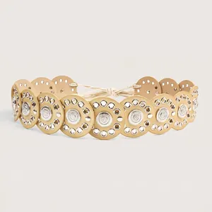 Detailed view of Bohemian belt with linked circular disks and silver metal grommets.