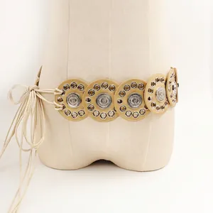 Detail of bohemian waist belt featuring circular discs and a long adjustable tie-up cord