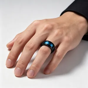 Detail of a black and blue tungsten steel ring on a male hand with polished finish
