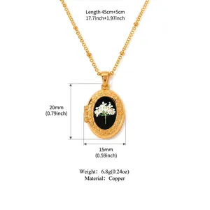 Vintage gold oval locket necklace with white dried flowers inside black background
