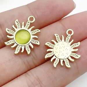 Miniature gold alloy sun charm with yellow resin center for creative DIY jewelry making projects