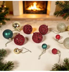Variety of red, gold, and green Christmas baubles with various textures and designs.