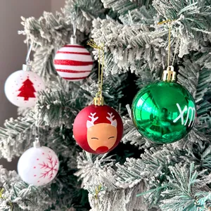 Detailed view of colorful assorted Christmas ball ornaments on a frosted pine tree