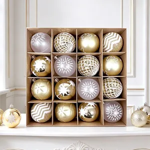 Set of 16 gold and white Christmas ball ornaments with various festive patterns in a box