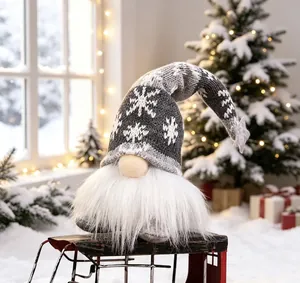 Handmade Christmas gnome with grey snowflake knit hat sitting on a vintage red sled detail