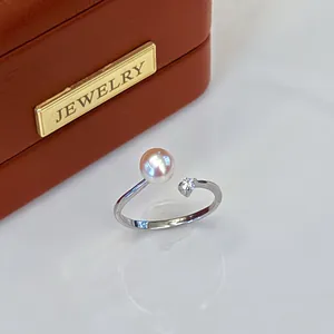 Elegant adjustable silver ring with natural freshwater pearl and sparkling gemstone detail