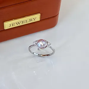 Close-up of a silver adjustable ring featuring a natural purple freshwater pearl