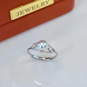 Close-up of elegant adjustable silver ring featuring a lustrous natural freshwater pearl.