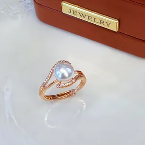 Detailed macro view of a natural freshwater pearl ring with sparkling pavé rose gold band