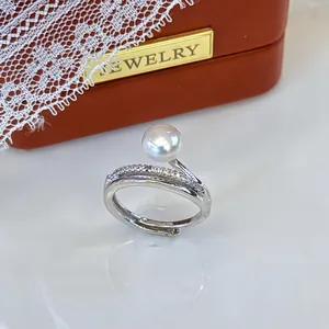 Detailed view of an adjustable silver ring featuring a natural freshwater pearl