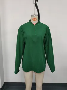 Detailed view of a green corduroy long sleeve half-zip polo shirt on a white mannequin
