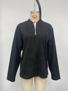 Detail view of a black men's corduroy half-zip pullover shirt with a stand-up collar