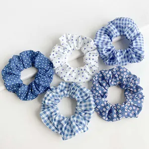 Assorted blue and white patterned scrunchies including polka dots and floral prints.