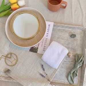 Soft white absorbent Velcro face wash headband for skincare and makeup on a rustic tray