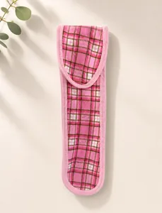 Detail view of a pink plaid velcro headband for makeup and facial cleansing